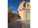 Side of two-story home with driveway access and backyard gate at 4466 Palm Grove Dr, Las Vegas, NV 89120