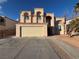 Charming two-story home features a two-car garage, desert landscaping and a Spanish-tile roof at 4466 Palm Grove Dr, Las Vegas, NV 89120