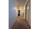 Carpeted hallway leading to multiple rooms, offering a simple and functional design at 4466 Palm Grove Dr, Las Vegas, NV 89120