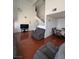 Bright living room featuring vaulted ceilings, wood floors, and a staircase at 4466 Palm Grove Dr, Las Vegas, NV 89120