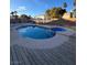 Inviting backyard featuring a sparkling pool with an attached spa, surrounded by a wood deck, perfect for relaxation at 4466 Palm Grove Dr, Las Vegas, NV 89120