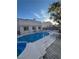 The backyard oasis features a refreshing pool, a cozy spa, a wood deck, and patio space for entertaining guests at 4466 Palm Grove Dr, Las Vegas, NV 89120