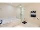 Spa-like bathroom featuring a soaking tub, glass shower, and marble finishes at 4471 Dean Martin Dr # 1002, Las Vegas, NV 89103