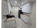 Bright kitchen featuring white cabinets, gas range, and refrigerator at 5100 Pebble Beach Blvd, Las Vegas, NV 89108
