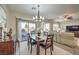 Dining area with wooden table and access to backyard at 6112 Canter Glen Ave, Las Vegas, NV 89122