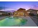 Backyard pool view featuring a gazebo and covered patio with ambient lighting, perfect for entertaining during twilight hours at 731 N Parawan St, Henderson, NV 89015