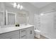 Modern bathroom with gray vanity, white countertop, and large shower at 7553 Mojave Wind Ave, Las Vegas, NV 89113