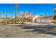 Exterior view of a home with a three car garage and palm trees at 7755 Coley Ave, Las Vegas, NV 89117
