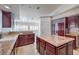 Island kitchen with granite countertops and dark wood cabinets at 7755 Coley Ave, Las Vegas, NV 89117