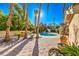 Relaxing pool area with palm trees and brick patio at 7755 Coley Ave, Las Vegas, NV 89117