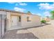 Front view of a single-story house with a white door and gravel driveway at 8221 Ten Gallon Ct, Las Vegas, NV 89129