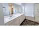 Bathroom featuring double vanity, soaking tub, and glass enclosed shower with tile surround at 846 Star Estates Ave, North Las Vegas, NV 89086