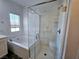 Bright bathroom featuring soaking tub and glass enclosed shower with window light at 846 Star Estates Ave, North Las Vegas, NV 89086
