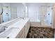 Bathroom featuring double vanity, soaking tub, and glass enclosed shower with tile surround at 846 Star Estates Ave, North Las Vegas, NV 89086