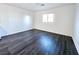 Bright bedroom features wood-look flooring and a window providing natural light at 846 Star Estates Ave, North Las Vegas, NV 89086