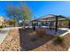 A well-maintained community park with a playground and covered picnic area under a clear blue sky at 846 Star Estates Ave, North Las Vegas, NV 89086