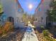 Charming walkway between modern townhomes, featuring neutral exteriors and manicured landscaping at 846 Star Estates Ave, North Las Vegas, NV 89086