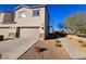 Attached two-car garage with paved driveway and low maintenance desert landscaping in the front yard at 846 Star Estates Ave, North Las Vegas, NV 89086