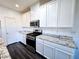 Modern kitchen features white cabinets, stainless steel appliances, and granite countertops at 846 Star Estates Ave, North Las Vegas, NV 89086