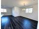 Well-lit living room featuring an open layout with wood-look floors and large windows at 846 Star Estates Ave, North Las Vegas, NV 89086