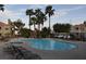 Community pool with hot tub and surrounding lounge chairs at 8600 W Charleston Blvd # 2101, Las Vegas, NV 89117