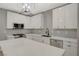 Modern kitchen with white cabinets, large island, and stainless steel appliances at 909 Rhyolite Ter, Henderson, NV 89011