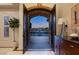 Elegant entryway with arched doorway revealing a courtyard and fountain at 9513 Verlaine Ct, Las Vegas, NV 89145