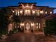 Stunning two-story home with beautiful landscaping and lighting at 9513 Verlaine Ct, Las Vegas, NV 89145