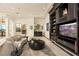 Gathering room with a large screen TV, comfortable seating, and wet bar at 9513 Verlaine Ct, Las Vegas, NV 89145