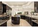 Island kitchen with granite countertops and stainless steel appliances at 9513 Verlaine Ct, Las Vegas, NV 89145
