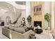 Living room with a stone fireplace, high ceilings and large windows at 9513 Verlaine Ct, Las Vegas, NV 89145