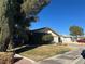 Single-story house with a large front yard and mature trees at 1004 Joseph Kerwin Dr, Las Vegas, NV 89145