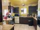 Bright kitchen with dark wood cabinets and yellow walls at 1004 Joseph Kerwin Dr, Las Vegas, NV 89145