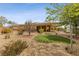 Landscaped backyard with a pergola-covered patio and artificial turf at 10372 Hawks Wing St, Las Vegas, NV 89178