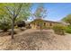 Landscaped backyard with gravel and trees at 10372 Hawks Wing St, Las Vegas, NV 89178