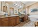 Elegant bathroom with a double vanity, granite countertops, and a soaking tub at 10372 Hawks Wing St, Las Vegas, NV 89178
