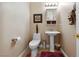 Clean and updated bathroom with pedestal sink and toilet at 10372 Hawks Wing St, Las Vegas, NV 89178