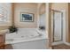 Relaxing bathroom with soaking tub and separate shower at 10372 Hawks Wing St, Las Vegas, NV 89178