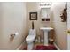 Clean bathroom with pedestal sink, toilet and built-in shelving at 10372 Hawks Wing St, Las Vegas, NV 89178