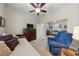 Bedroom with daybed, recliner, and ceiling fan at 10372 Hawks Wing St, Las Vegas, NV 89178