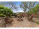Backyard fire pit area with stone patio and seating at 10372 Hawks Wing St, Las Vegas, NV 89178