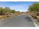 Inviting gated entrance to the community with landscaping and security features at 10372 Hawks Wing St, Las Vegas, NV 89178