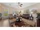 Cozy Gathering room with a comfortable leather sofa and access to backyard at 10372 Hawks Wing St, Las Vegas, NV 89178