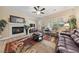 Relaxing Gathering room with a fireplace and comfortable seating at 10372 Hawks Wing St, Las Vegas, NV 89178