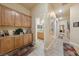 Bright hallway with wood cabinets and tile flooring at 10372 Hawks Wing St, Las Vegas, NV 89178
