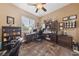 Spacious home office with wood furniture and large windows at 10372 Hawks Wing St, Las Vegas, NV 89178