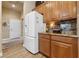 White refrigerator and wood cabinets in kitchen at 10372 Hawks Wing St, Las Vegas, NV 89178