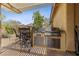 Outdoor kitchen with stainless steel appliances at 10372 Hawks Wing St, Las Vegas, NV 89178