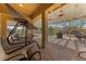 Relaxing patio area with comfortable seating and a pergola for shade at 10372 Hawks Wing St, Las Vegas, NV 89178
