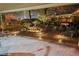 Night view of a spacious patio with a fire pit and a relaxing water feature at 10372 Hawks Wing St, Las Vegas, NV 89178
